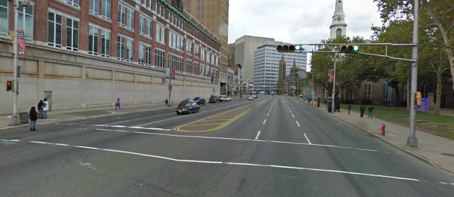 This crosswalk, which leads to Military Park (right) crosses seven lanes of traffic. A crossing island in the center lane would improve safety here. | Photo: Google Maps
